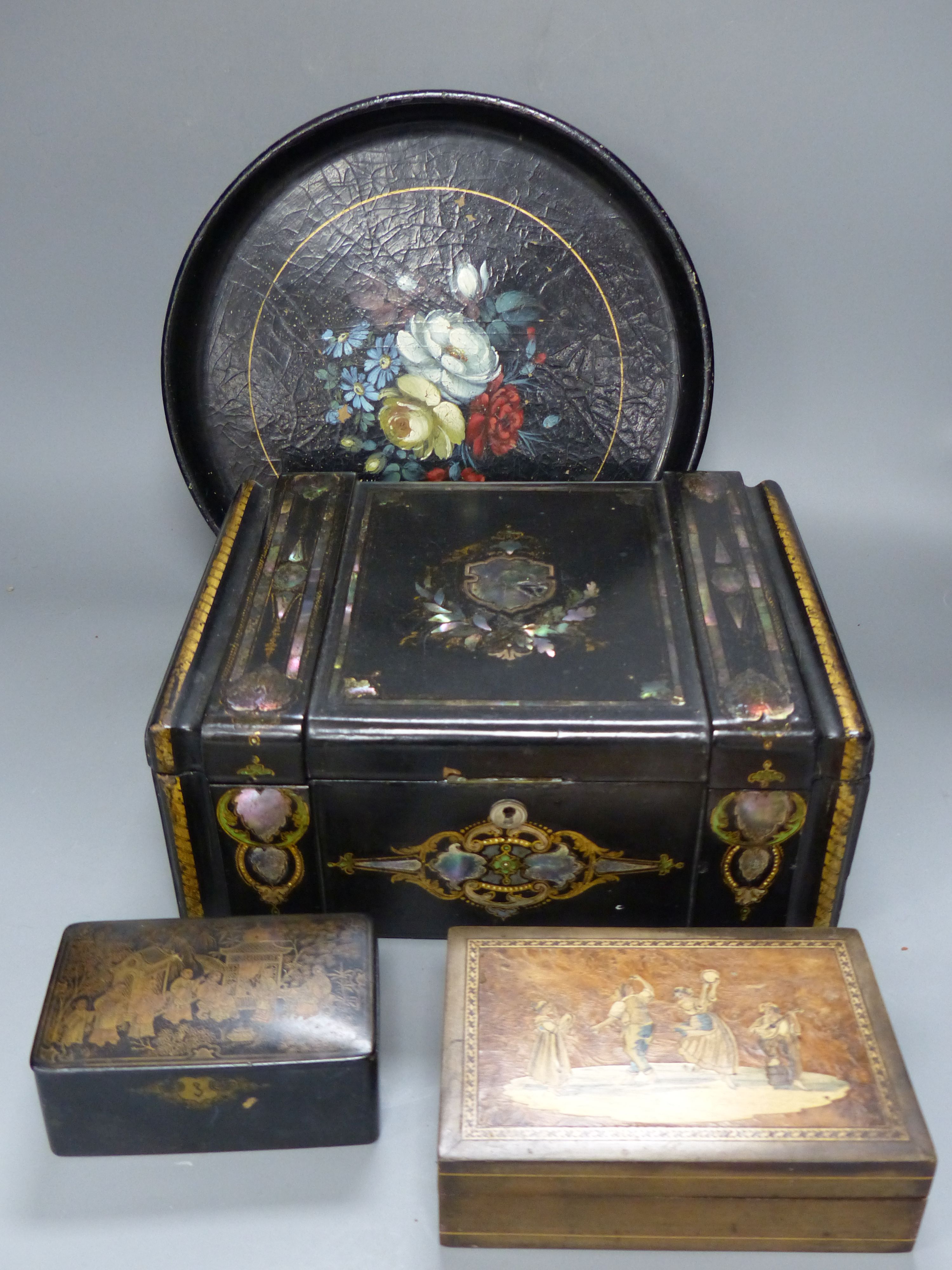 A mother of pearl inlaid lacquer writing box, two smaller boxes and a circular tray